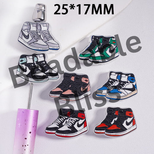 Collection of miniature sneaker models on a stand with 'hollisupply' branding.