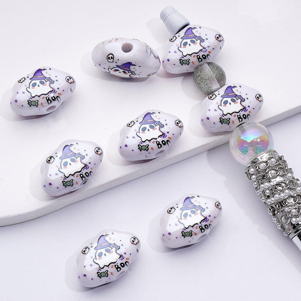 Decorative beads with cartoon character designs on a white surface

