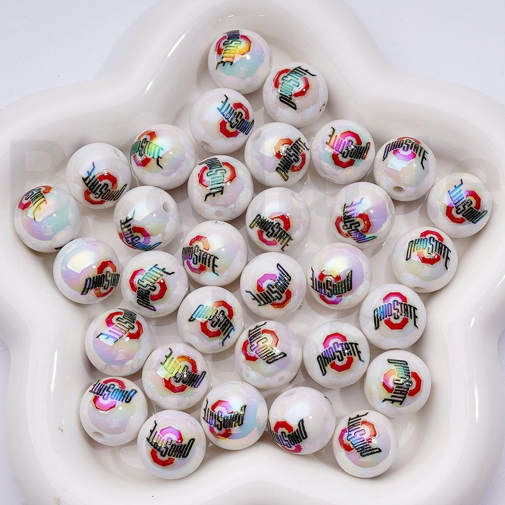White beads with colorful logos arranged in a white bowl

