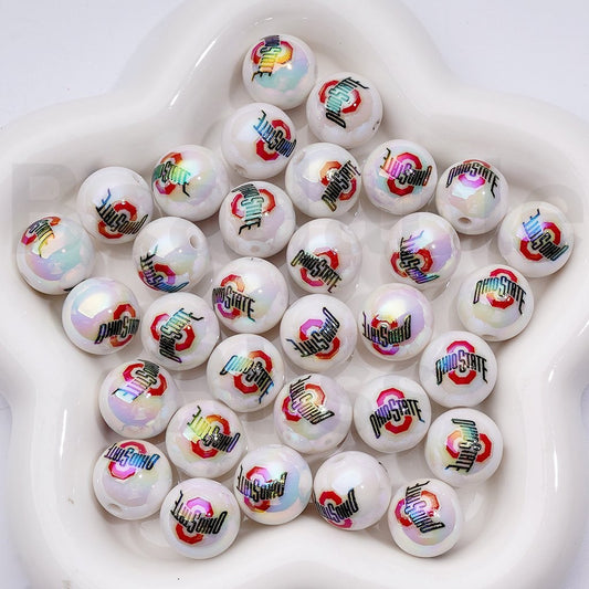 White beads with colorful logos arranged in a white bowl

