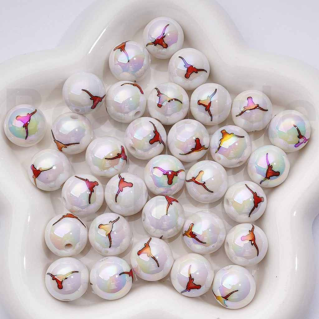 White beads with colorful designs on a white surface

