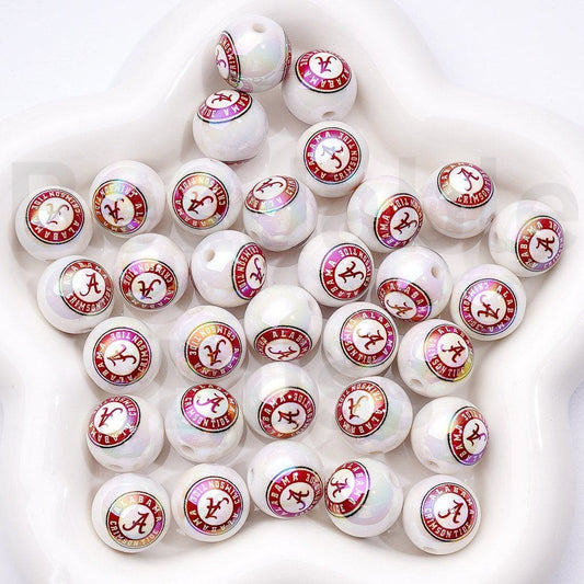 White beads with red and pink logos arranged on a white surface

