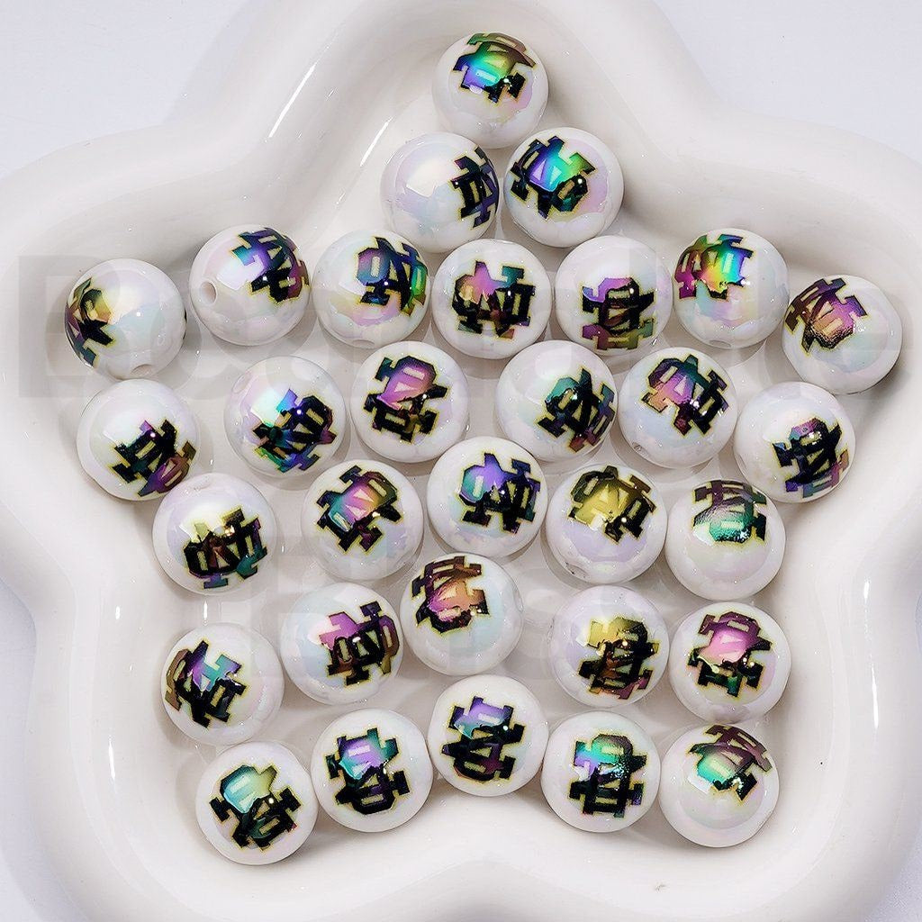 White beads with colorful geometric patterns on a white surface

