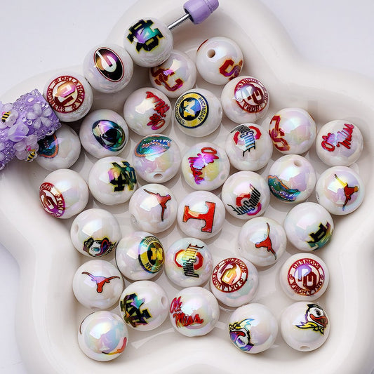 Collection of white beads with colorful designs on a white surface

