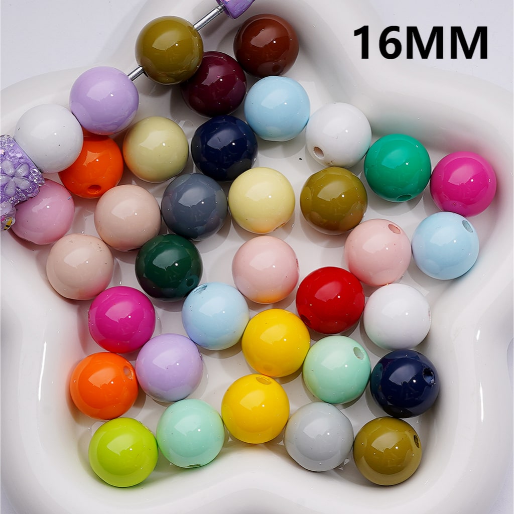 Assorted colored beads in a white dish with '16MM' text.

