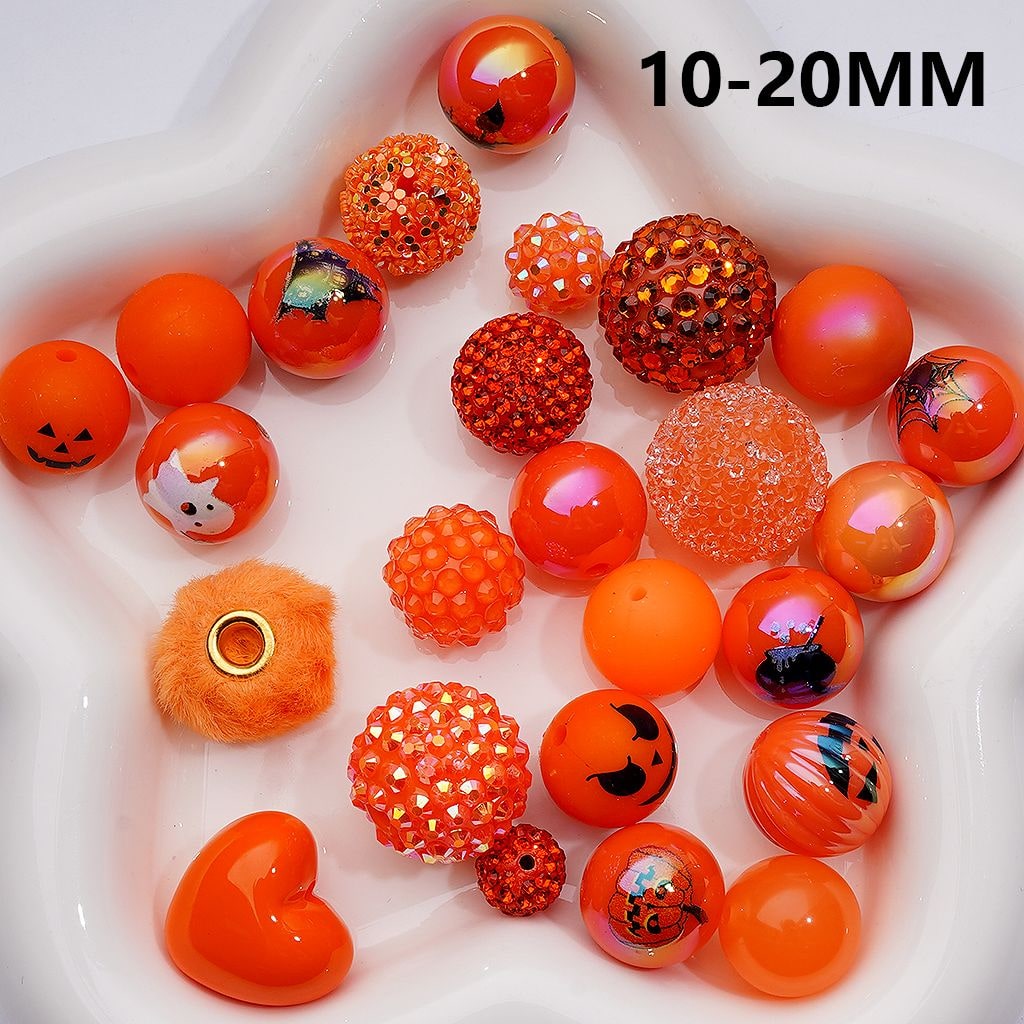 Assorted orange beads with Halloween designs on a white background, labeled '10-20MM'.

