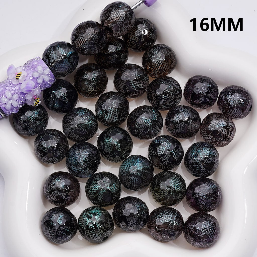Black beads on a white surface with '16MM' text

