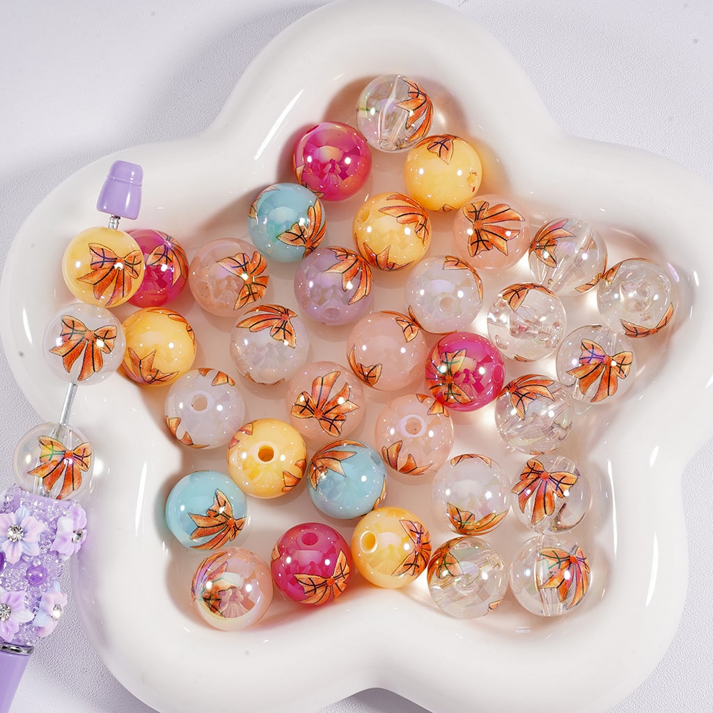Colorful bubblegum beads with floral designs on a white heart-shaped tray

