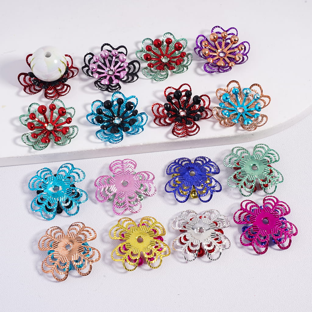 Assorted colorful flower-shaped jewelry pieces on a white background