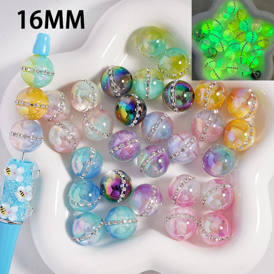 Colorful beads with decorative elements on a white tray, including a close-up of a green bead.

