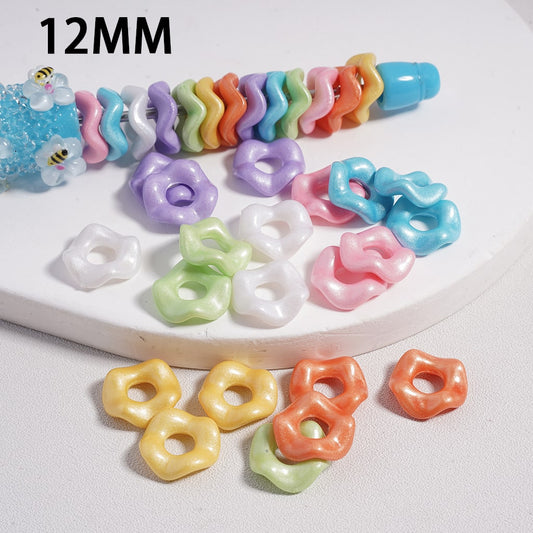 Assorted colorful hair ties and rubber bands on a white surface with '12MM' text.

