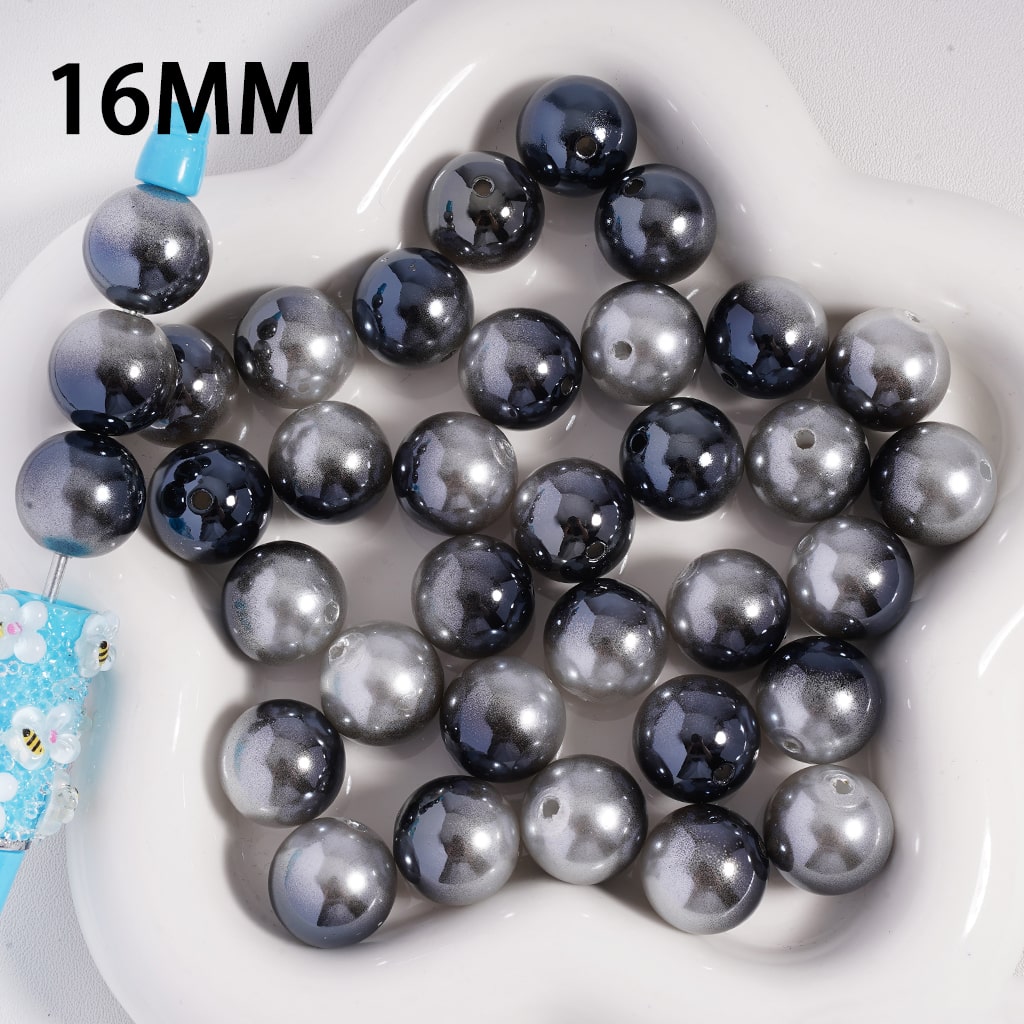 16MM black and gray beads on a white plate