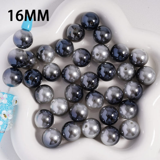 16MM black and gray beads on a white plate