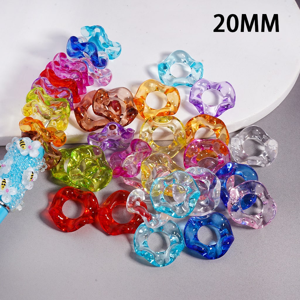 Colorful acrylic rings on a gray surface with '20MM' text.

