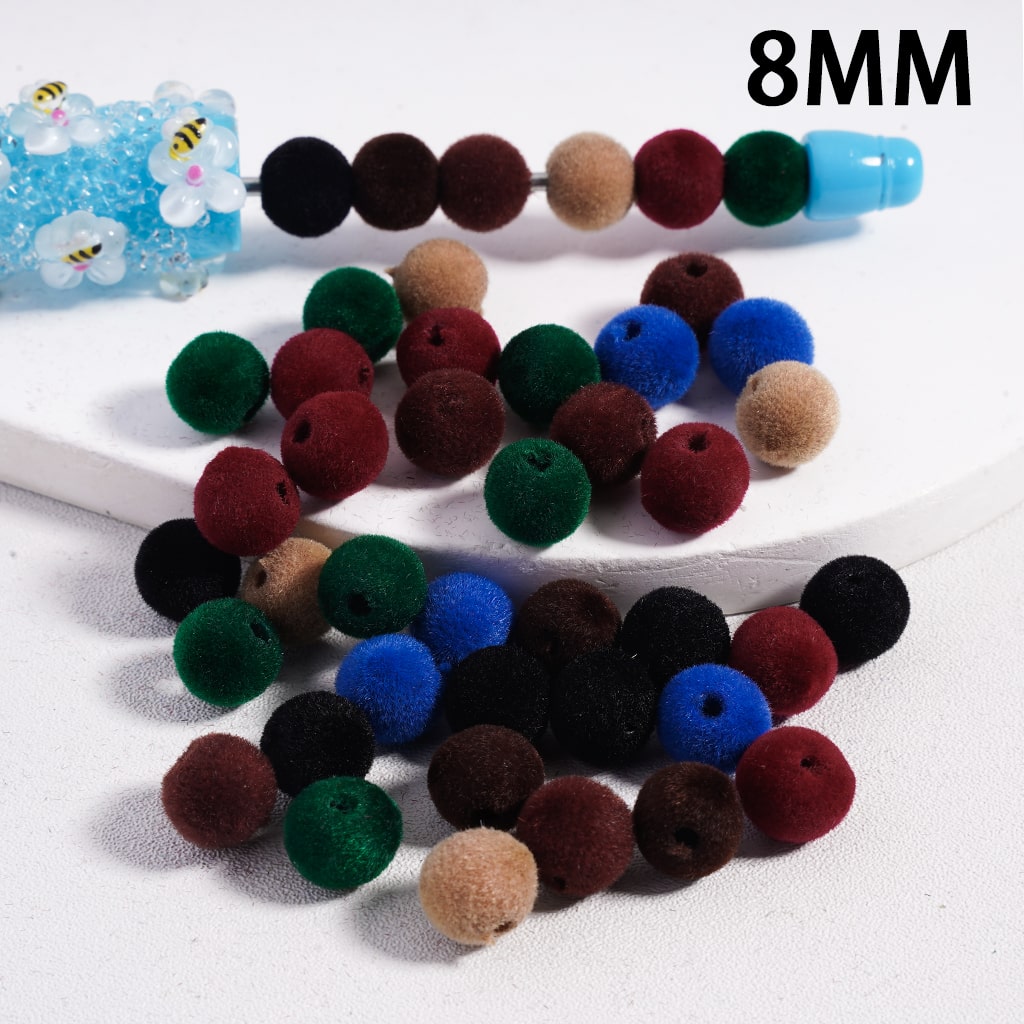 Colorful fuzzy beads on a white surface with '8MM' text.

