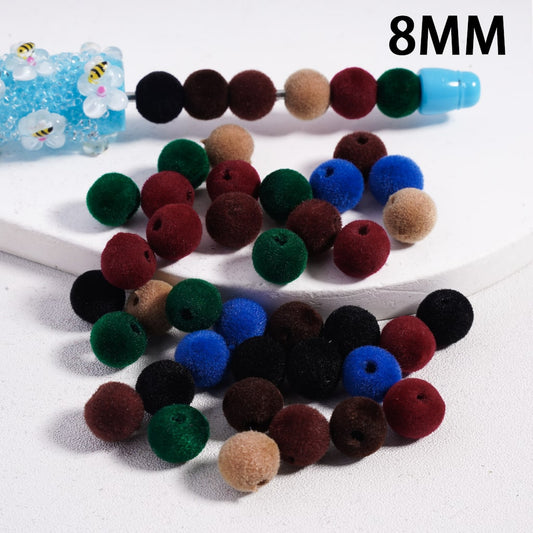 Colorful fuzzy beads on a white surface with '8MM' text.

