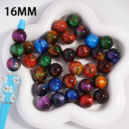 Multicolored beads on a white heart-shaped tray with a blue tool

