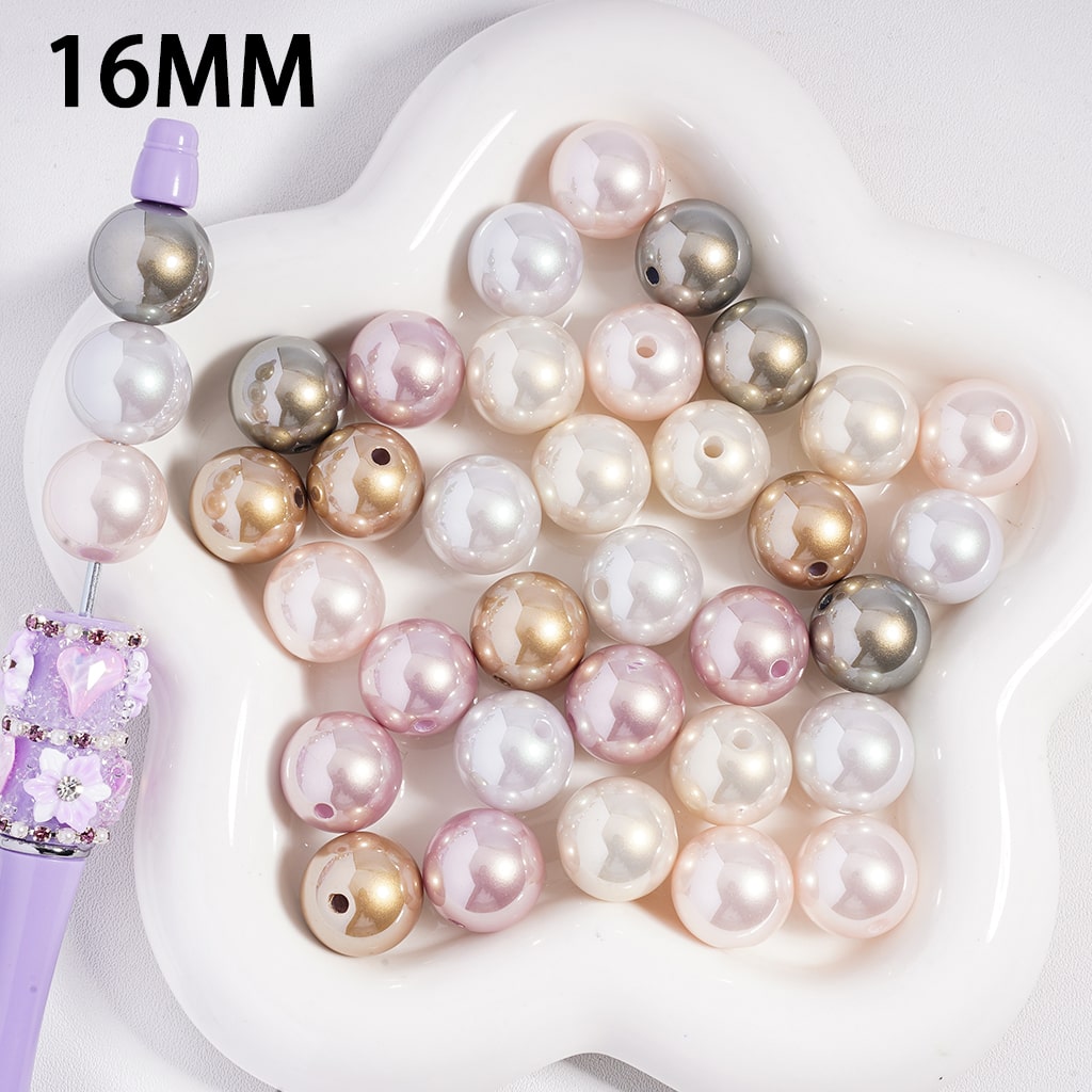 Assorted colored pearls on a white dish with '16MM' text
