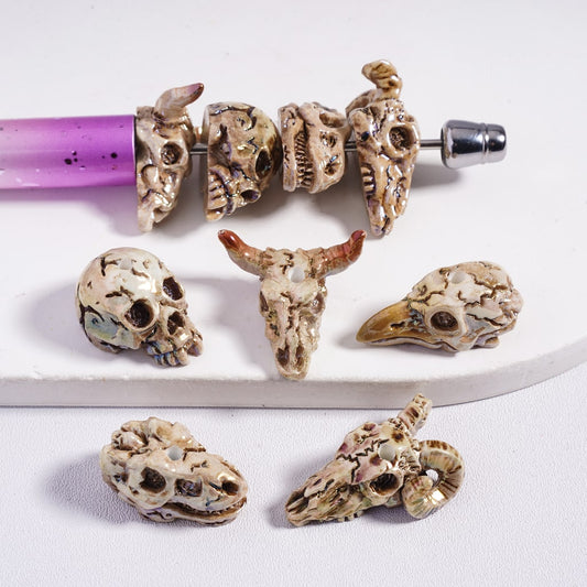 Decorative skull-shaped beads on a white background