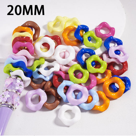 Assorted colorful plastic rings with a purple tool on a white background, labeled '20MM'.