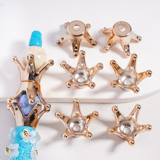 Decorative star-shaped objects with gold and silver finishes on a white background