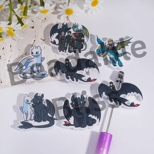 Set of 'How to Train Your Dragon' themed pins on a white background with flowers.

