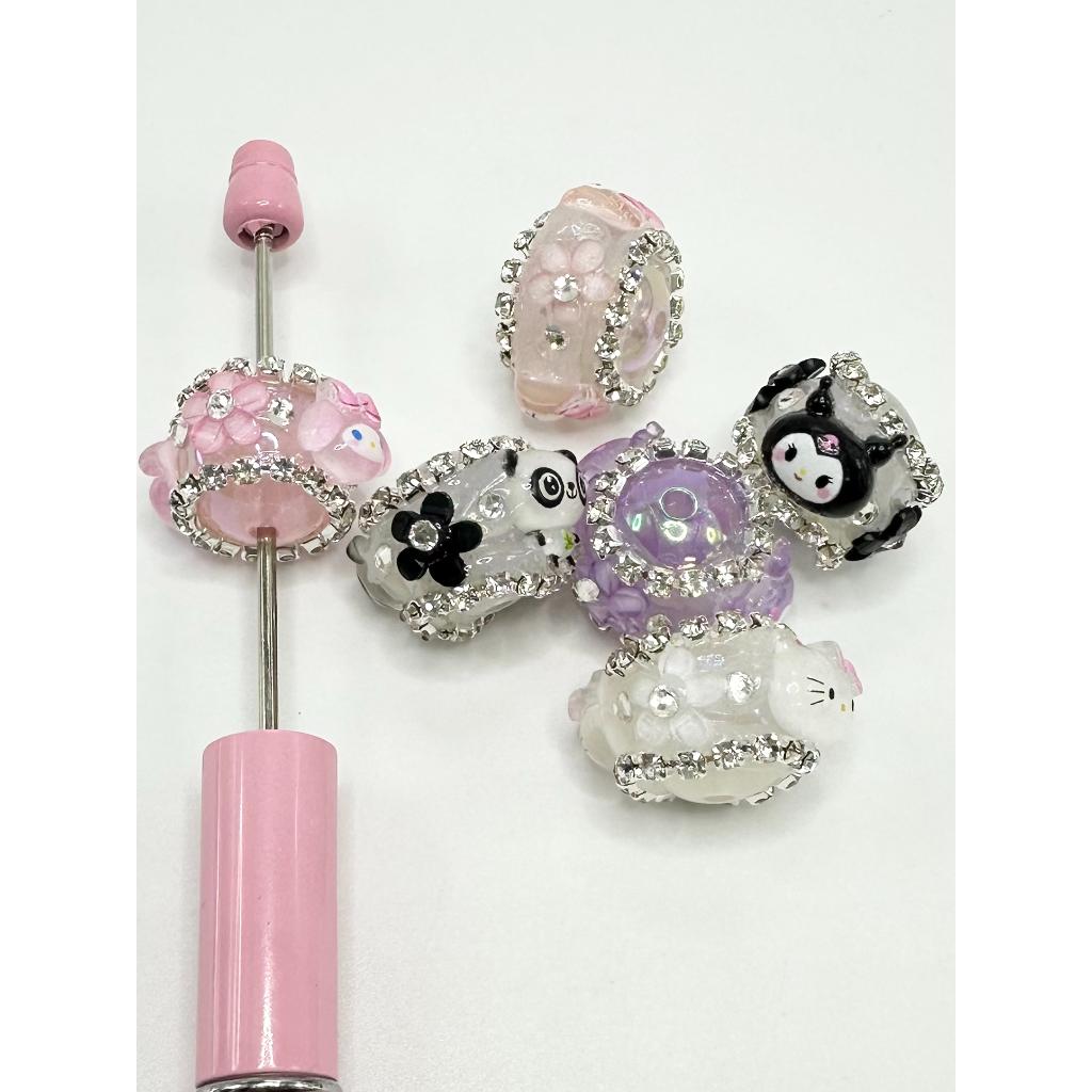 A collection of multicolored acrylic beads with rhinestones, designed to be used in crafting or jewelry making.


