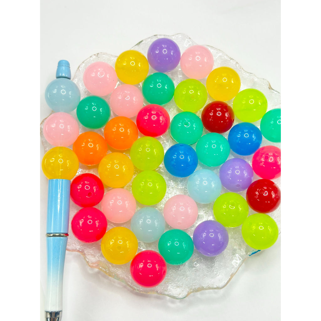 Colorful bubblegum beads in a clear container on a white background

