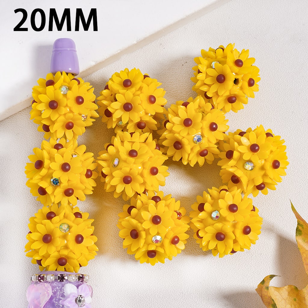 Yellow flower-shaped objects with a purple handle on a white background