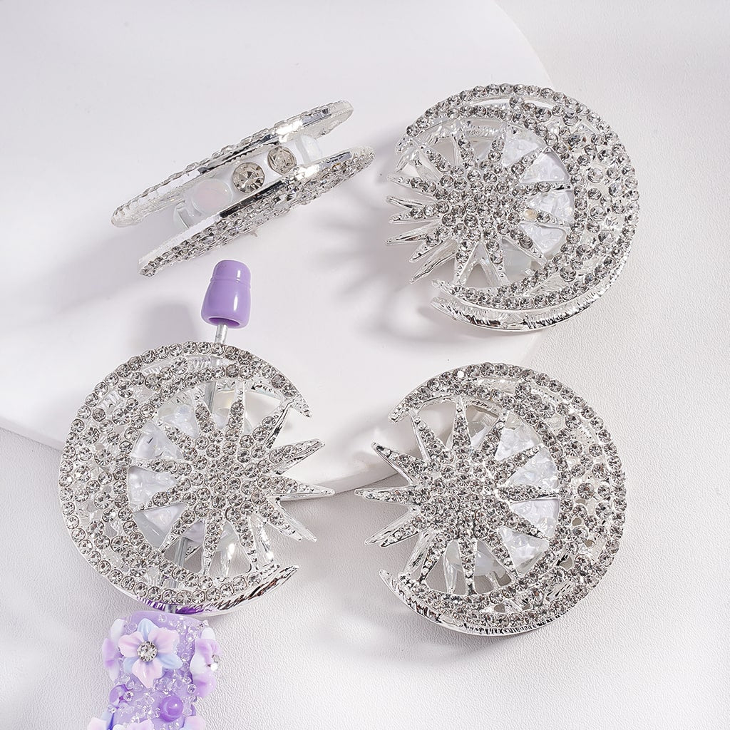 Silver alloy beads designed as crescent moons and suns, decorated with clear rhinestones and pearls.

