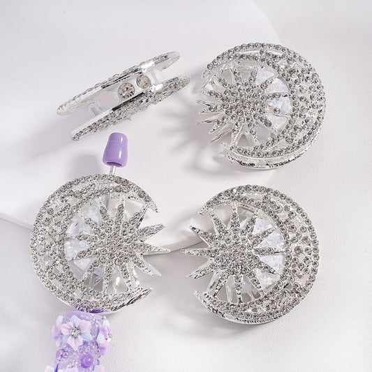 Silver alloy beads designed as crescent moons and suns, decorated with clear rhinestones and pearls.

