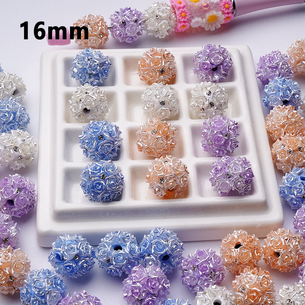 Assorted floral beads in various colors on a white tray with '16mm' text.

