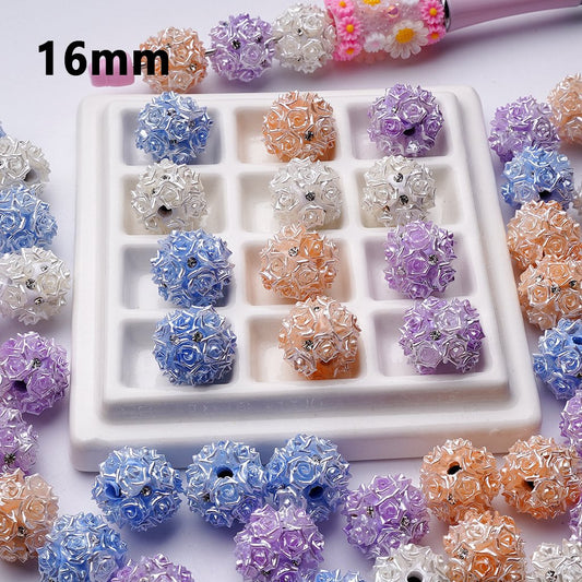 Assorted floral beads in various colors on a white tray with '16mm' text.

