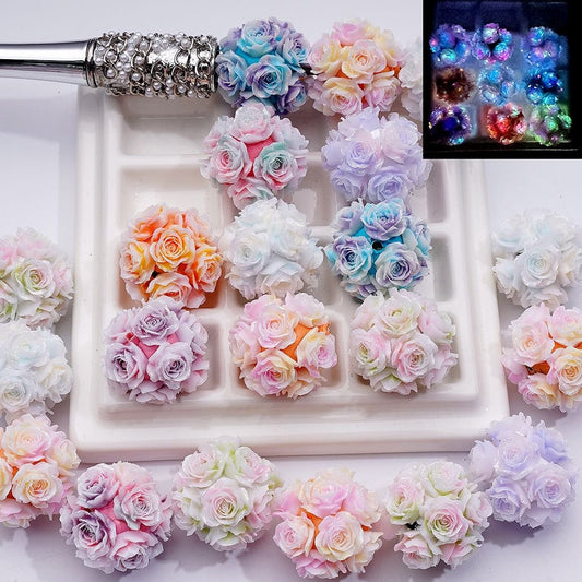 Decorative letter 'S' made of colorful artificial flowers on a white background.


