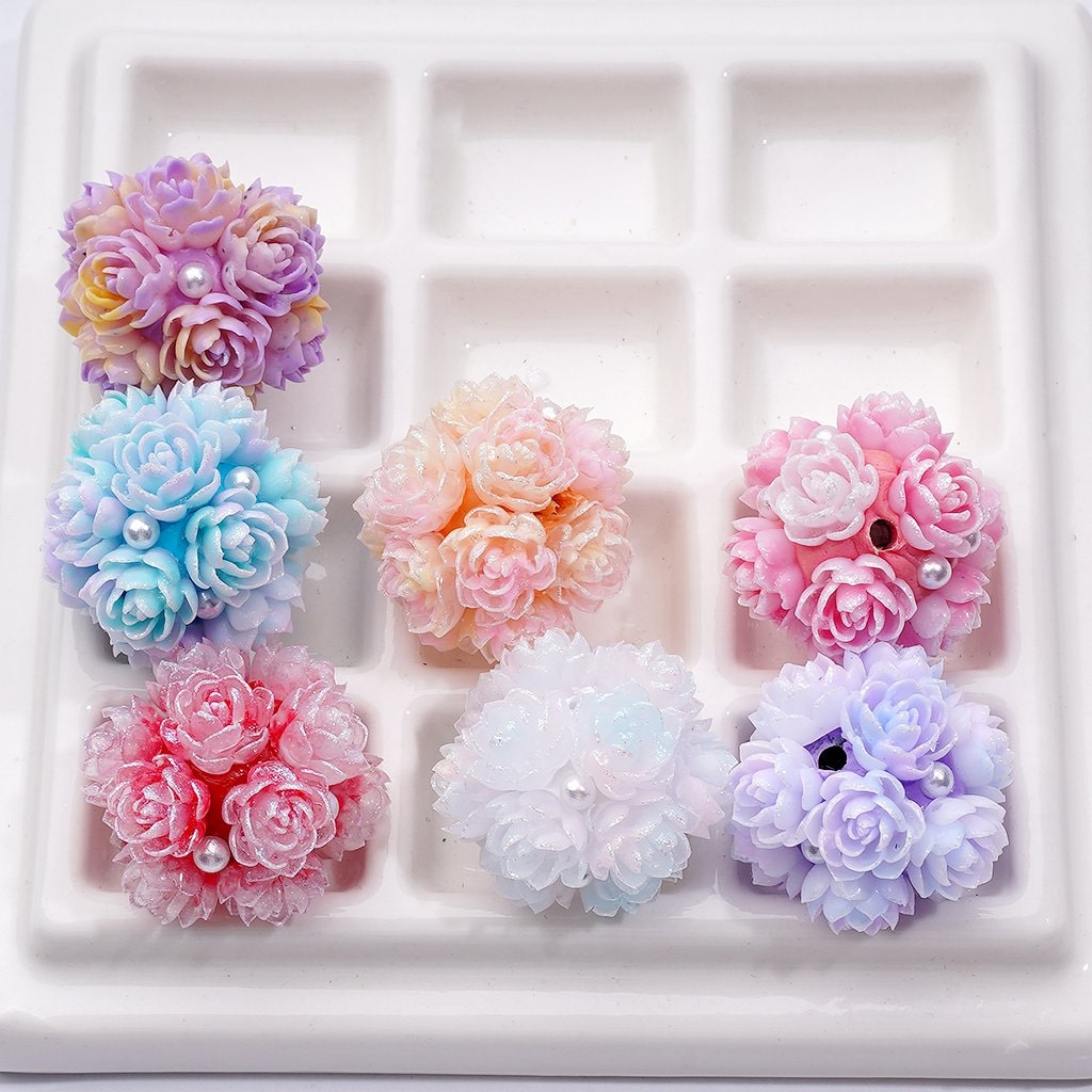 Pastel-colored flower-shaped candies on a white grid background

