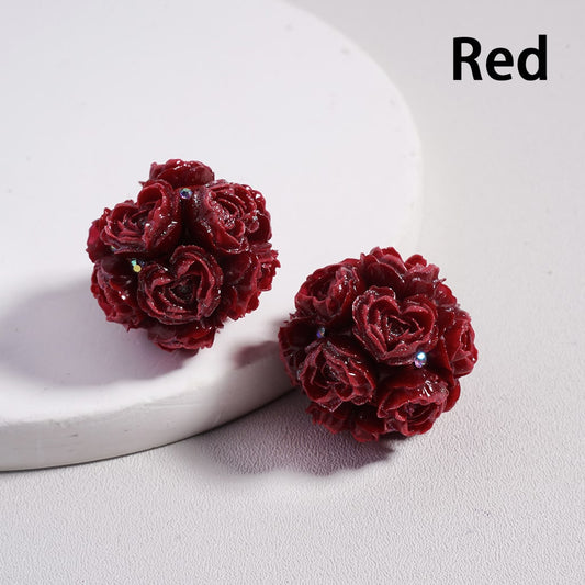 Red floral earrings on a light gray background with 'Red' text above.

