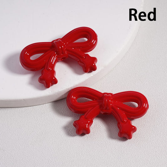 Two red bow-shaped hair clips on a white background with 'Red' text.

