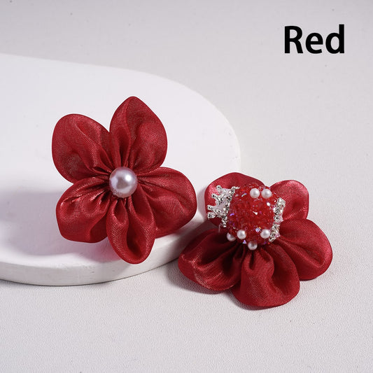Two red floral hair accessories with pearls on a white background

