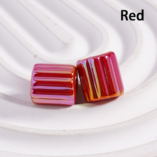 Red striped earrings on a white background


