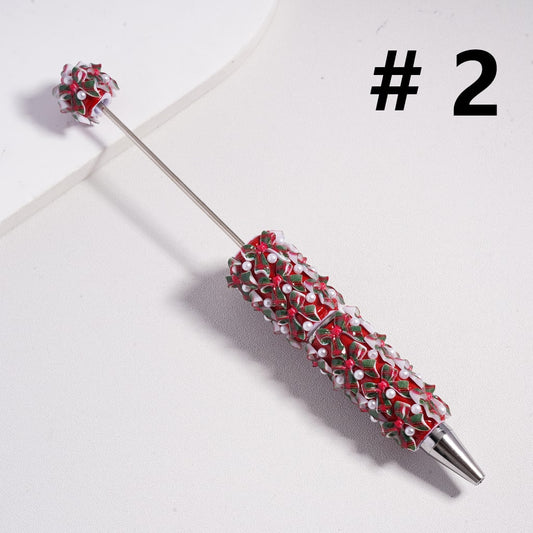 Decorative pen with red and white bead pattern on a light gray background

