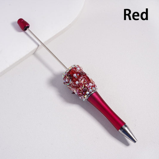 Decorative pen with red and silver design on a white background

