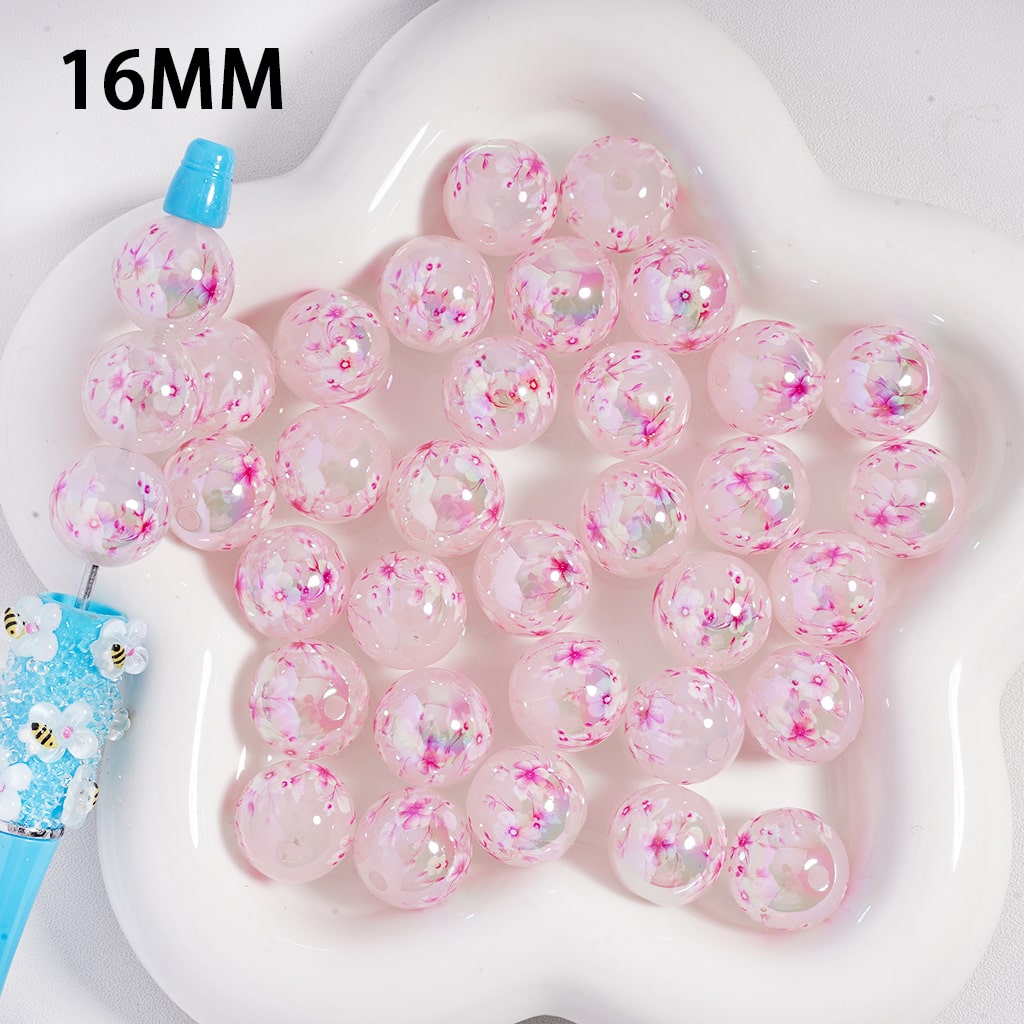 Pink bubble gum beads with sprinkles on a white tray, labeled '16MM'.