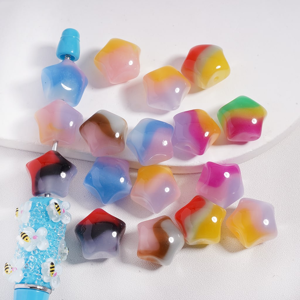 Colorful star-shaped ice cubes with a blue bottle on a white background