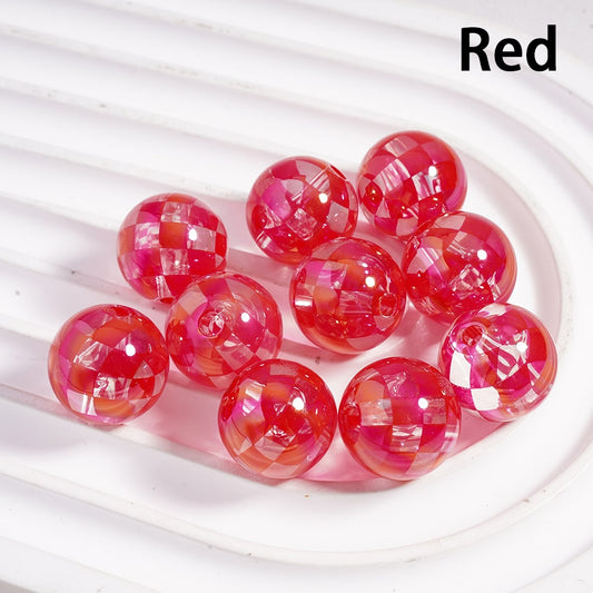 Red and pink marbled beads on a white background


