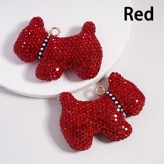 Red dog-shaped earrings on a white plate with 'Red' text above.

