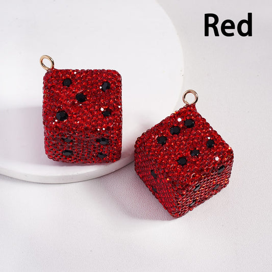 Red dice-shaped earrings with black dots on a white background

