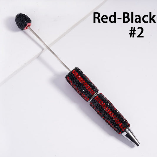 Red and black pen with decorative top on a white background

