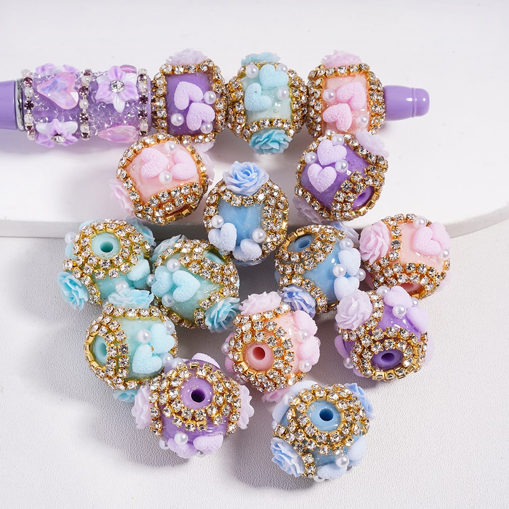 Decorative hair ties with floral and heart designs on a white background