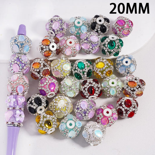 Assorted colorful beads with a purple tool on a white background, labeled '20MM'.