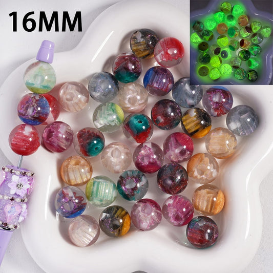Assorted colored beads on a white tray with a close-up inset showing glowing green beads.